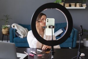 Creator making makeup vlog with her smartphone